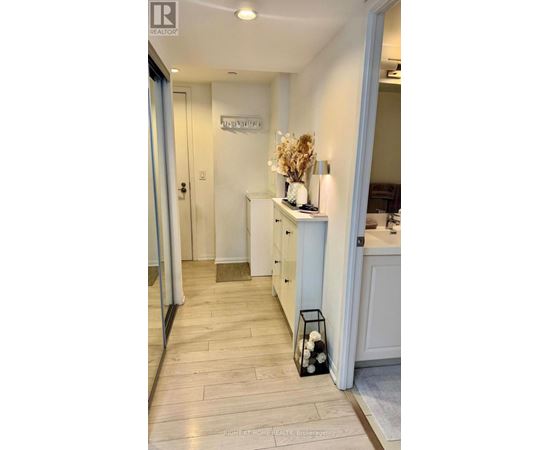 A hallway with a sign that says "ENTRANCE" on the wall.