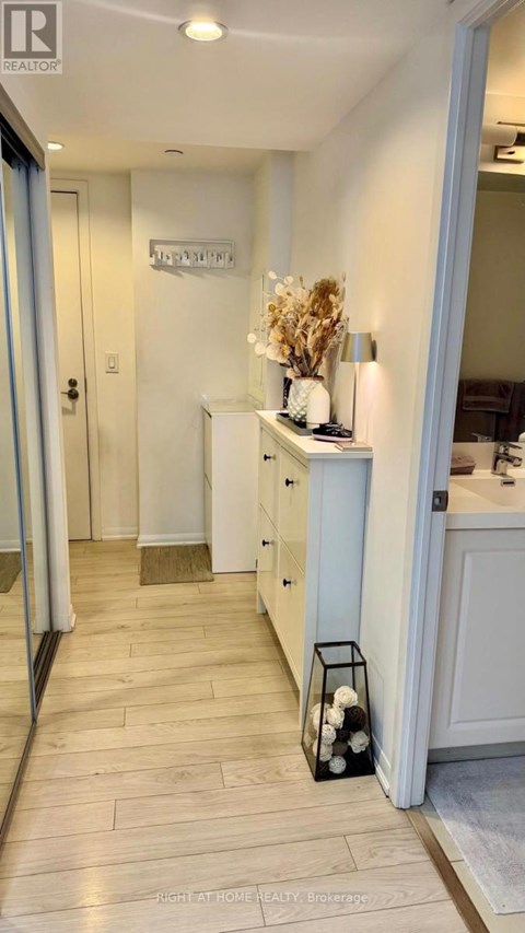 A hallway with a sign that says "ENTRANCE" on the wall.