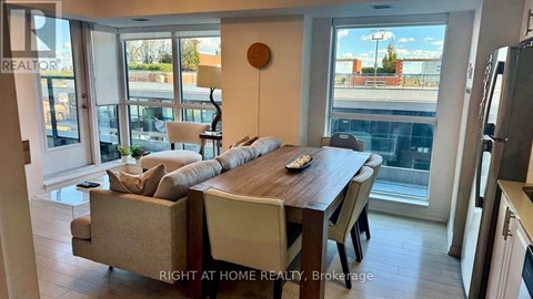 A modern dining room with a wooden table and chairs.