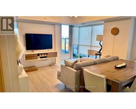 A modern living room with a flat screen TV and a wooden coffee table.