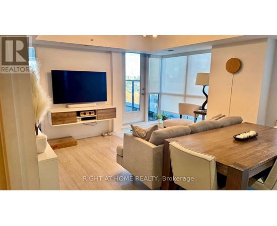 A modern living room with a flat screen TV and a wooden coffee table.