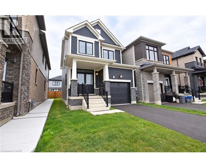 A modern two-story house with a black front door and a garage.