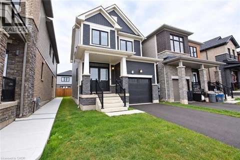 A modern two-story house with a black front door and a garage.