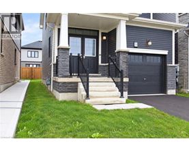 A modern house with a black front door and a black garage door.