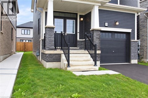 A modern house with a black front door and a black garage door.