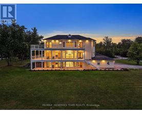 A large, well-lit house with the RE/MAX Hendriks Team Realty logo on the top left corner.