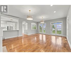 A spacious room with wooden floors and white walls.