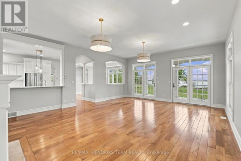A spacious room with wooden floors and white walls.