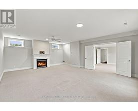 A spacious living room with a fireplace and a television.