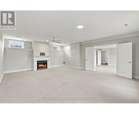 A spacious living room with a fireplace and a television.