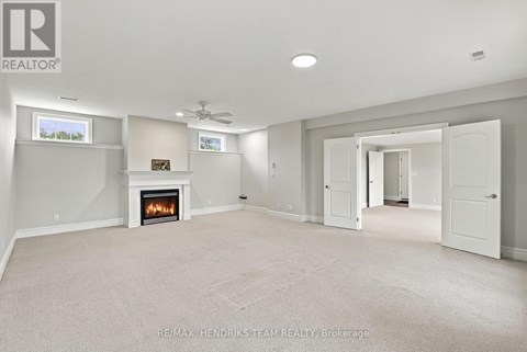 A spacious living room with a fireplace and a television.