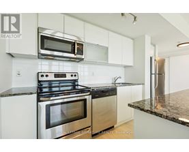 A modern kitchen with a stainless steel oven and microwave.