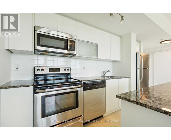 A modern kitchen with a stainless steel oven and microwave.