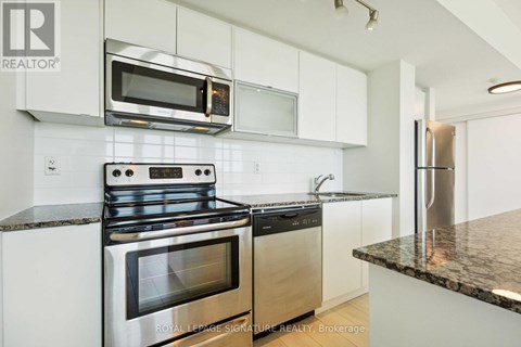 A modern kitchen with a stainless steel oven and microwave.