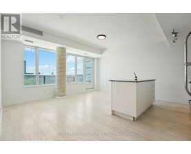 A spacious room with a reception desk and large windows.