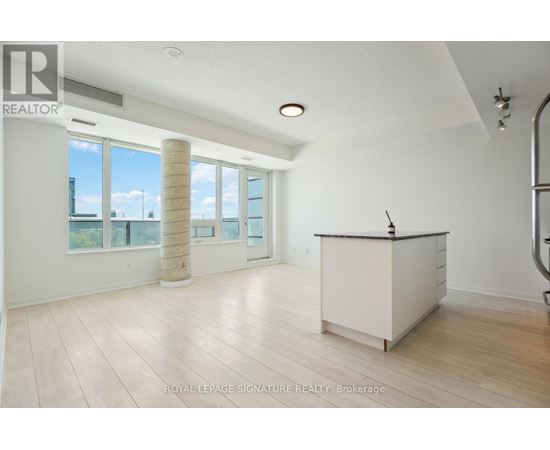 A spacious room with a reception desk and large windows.