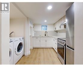 A modern kitchen with stainless steel appliances and white cabinets.