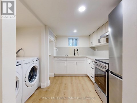 A modern kitchen with stainless steel appliances and white cabinets.