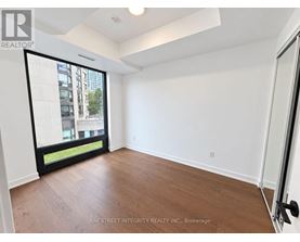 A room with a sliding glass door leading to a balcony.