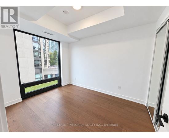 A room with a sliding glass door leading to a balcony.