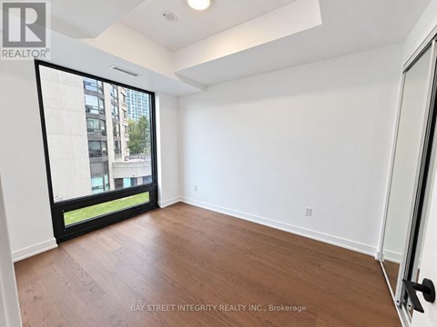 A room with a sliding glass door leading to a balcony.