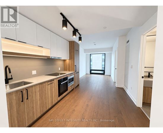 A modern kitchen with wooden cabinets and a large island.