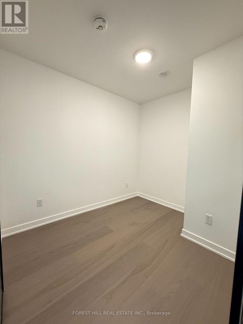 A room with wood flooring and white walls.