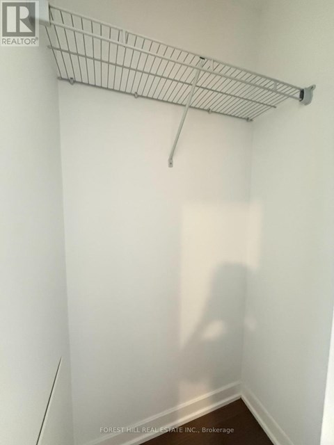 A white wall with a metal rack on it.