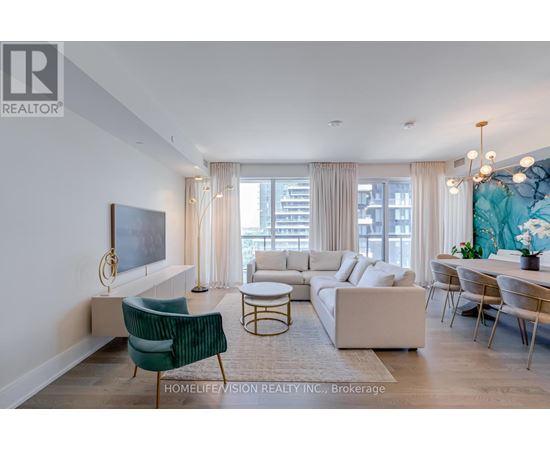 A living room with a green chair and a white sofa.