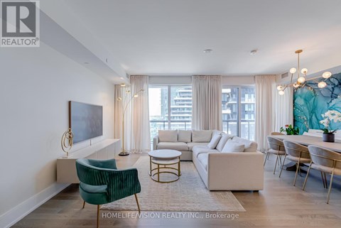 A living room with a green chair and a white sofa.