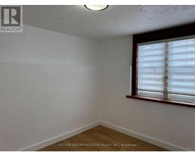 A room with a window covered in blinds.