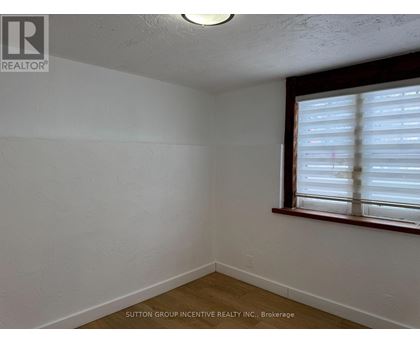 A room with a window covered in blinds.
