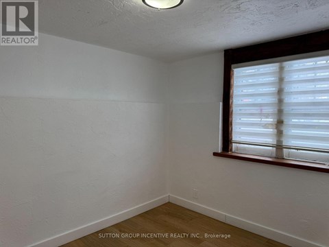A room with a window covered in blinds.