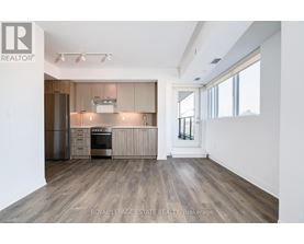 A spacious kitchen with wooden floors and modern appliances.