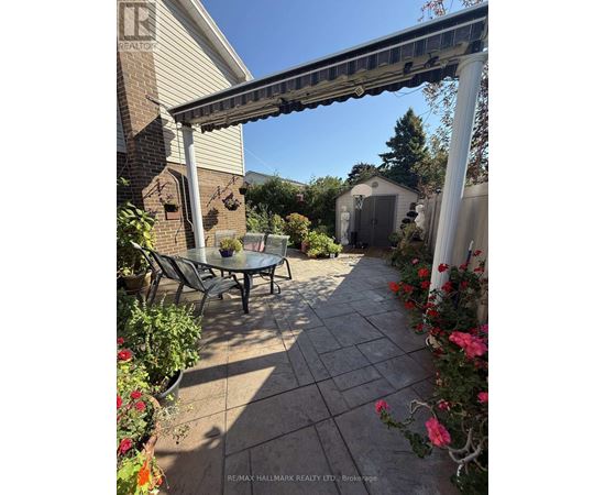 A patio with a table and chairs under a pergola.