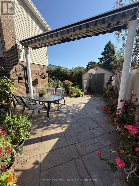 A patio with a table and chairs under a pergola.