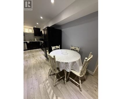 A dining room with a table and chairs.