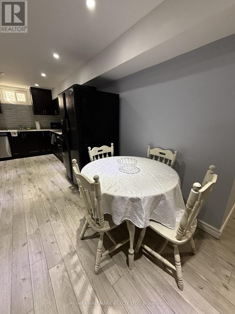 A dining room with a table and chairs.