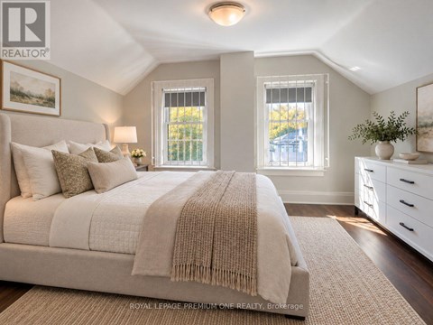 A bedroom with a large bed and a window.