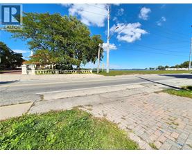A street view with a REALTOR sign in the corner.