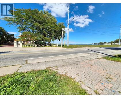 A street view with a REALTOR sign in the corner.