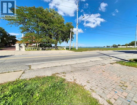A street view with a REALTOR sign in the corner.