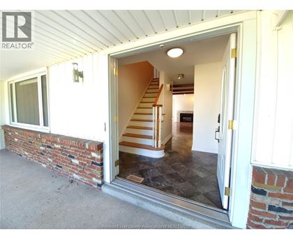 A house with a staircase leading to the second floor is for sale.