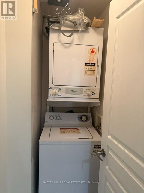 A small white fridge with a stove underneath it.