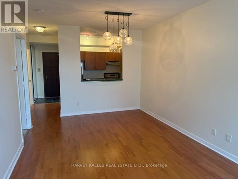 A room with wooden floors and a mirror on the wall.