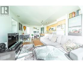 A living room with a grey couch and a television.
