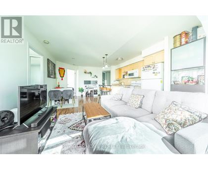 A living room with a grey couch and a television.