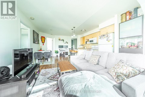 A living room with a grey couch and a television.