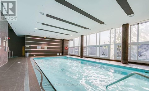 A large indoor swimming pool with a long lane in the middle.