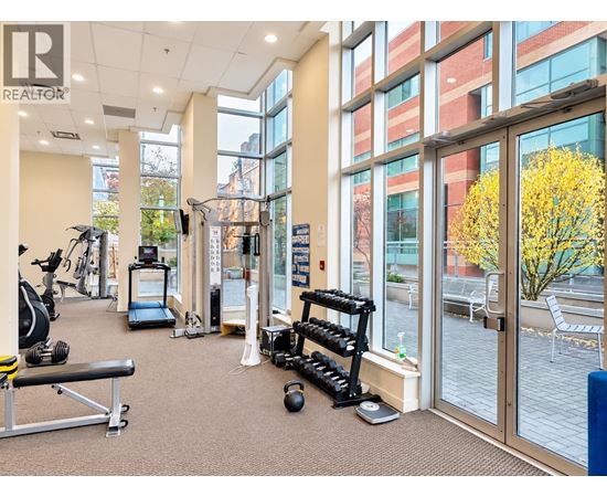 A gym with a variety of equipment including weights and cardio machines.